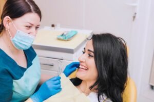 dentist-sitting-near-female-patient_23-2148085301