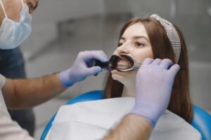 female-patient-with-braces-has-dental-examination-dentist-office-woman-wearing-white-clothes_1157-49539