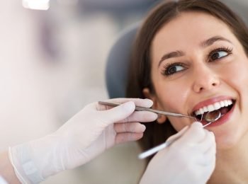 Woman having teeth examined at dentists